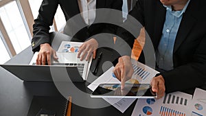 Cropped image of business people talking/meeting/discussing about their business plan by using a computer laptop and tablet.