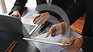 Cropped image of business people talking/meeting/discussing about their business plan by using a computer laptop and tablet.