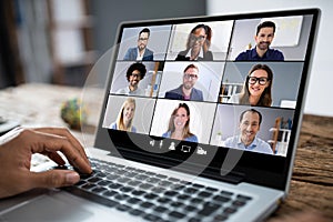 Man Working From Home Having Group Videoconference On Laptop