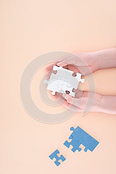 cropped image of businesswoman holding assembled puzzles piece in hands