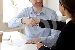 Diverse business partners starting negotiations shaking hands photo