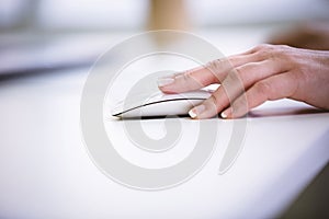 Cropped image of businesswoman using mouse at office