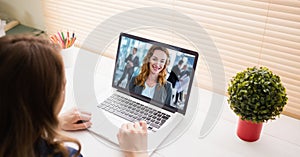 Cropped image of businesswoman video conferencing on laptop