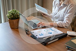 Cropped image of a businesswoman working in her office, responding to an email on her laptop