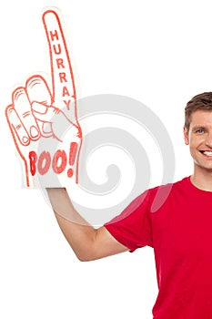 Cropped image of a casual guy with big foam hand