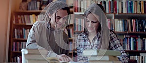 Cropped image of college students learning in library