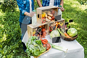 cropped image of couple of farmers setting stall