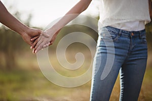 Cropped image of couple holding hands