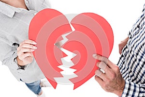 cropped image of couple holding two pieces of paper heart