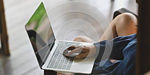 Cropped image creative woman`s hands typing on computer laptop keyboard that putting on her lap.