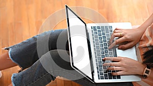 Cropped image creative woman typing on white blank screen computer laptop that putting on her lap.