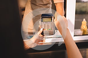 cropped image of customer paying with credit card at food truck