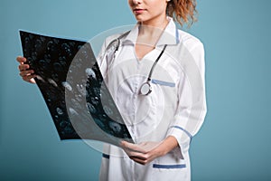 Cropped image of female doctor holding roentgenogram photo