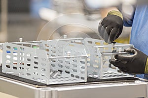 Cropped image of female engineer repairing computer part in manufacturing industry