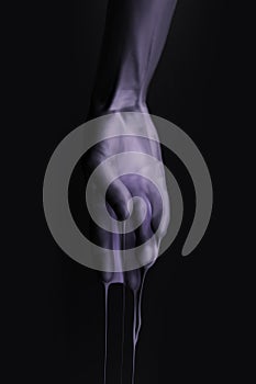 Cropped image of female hand in purple paint