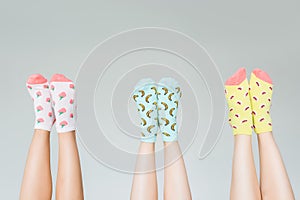 cropped image of female legs in different colorful socks