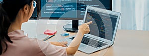 Female developer coding on laptop while computer display program. Burgeoning.