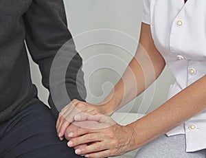 Female health care worker offering comfort to distressed patient