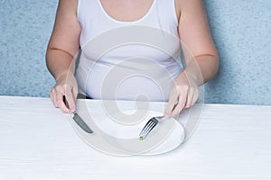 Cropped image of a girl eating peas. weight loss diet. Eating disorder