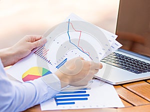 Cropped image hands with financial charts papers
