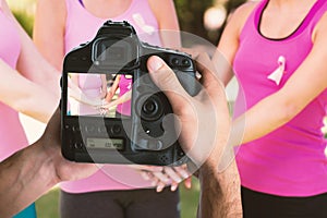 Composite image of cropped image of hands holding camera