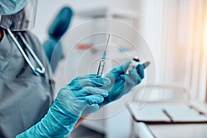 Cropped image of hands holding a covid-19 vaccine and a syringe. Vaccination and preservation and protection of health