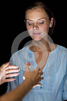 Cropped image of hypnotist hypnotizing woman