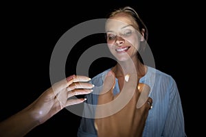 Cropped image of hypnotist hypnotizing woman