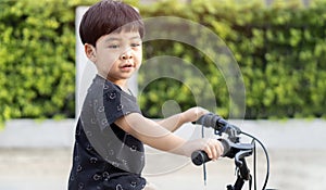 Cropped image of Kid outdoors sport summer activities in city park road yard garden forest