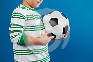 Cropped image of a little boy holding soccer ball