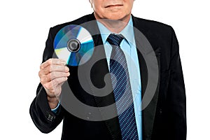 Cropped image of a male showing compact disk