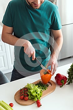 cropped image of man cutting vegetables for vegetarian salad