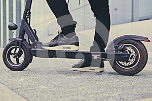 Cropped image of a man on an electric scooter.