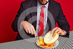 Cropped image of man in official suit touching mean against red background. Passion and hidden taste