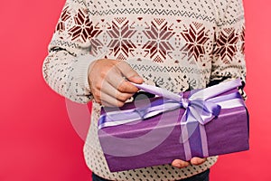 cropped image of man opening gift box