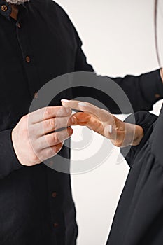 Cropped image of man putting on an engagement ring on his girlfriend& x27;s finger