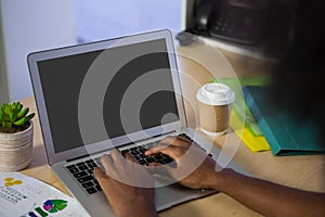 Cropped image of man using laptop in offce