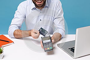 Cropped image of man work at desk with pc laptop isolated on blue background. Achievement business career concept. Hold