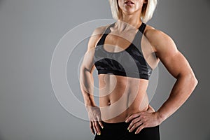 Cropped image of a muscular woman in sportswear