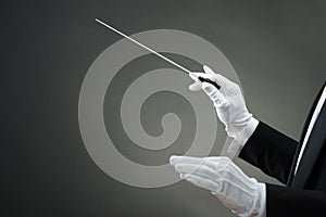 Music Conductor`s Hand Instructing With Baton photo