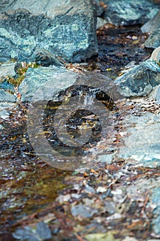 Cropped image of natural waterfall, water falling over the stone