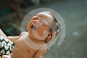 Cropped image of newborn sunbathing baby