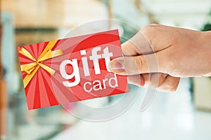 Person`s Hand Holding Gift Card