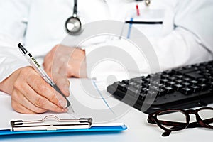 Cropped image of a physician writing prescription