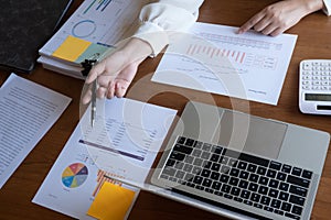 Cropped image of professional businesswoman, entrepreneur or accountant working on a financial report paperwork at her desk