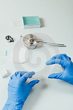 cropped image of scientist in latex gloves examining analysis in modern