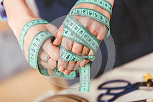 cropped image of seamstress hands winded up