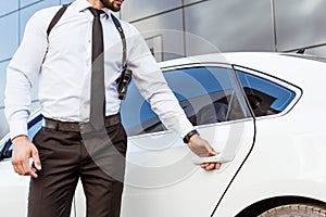 cropped image of security guard with gun opening