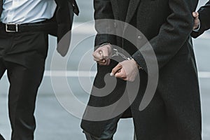 Cropped image of security guard holding man