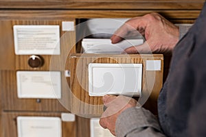 cropped image of senior male archivist searching photo